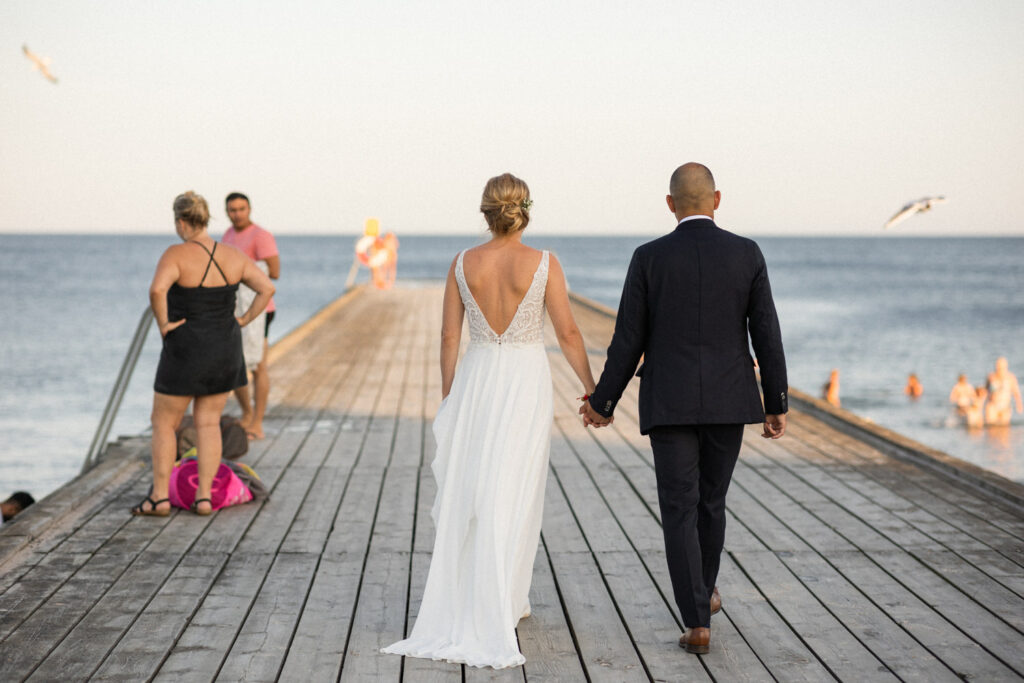 Sofi och Anil valde att ha ett destinationsbröllop på lyxiga hotell spa:et Ystad Saltsjöbad för sitt svensk-indiska strandbröllop. Bild tagen under tidig Golden Hour på YSB´s brygga. Foto: Tove Lundquist, bröllopsfotograf i Skåne.